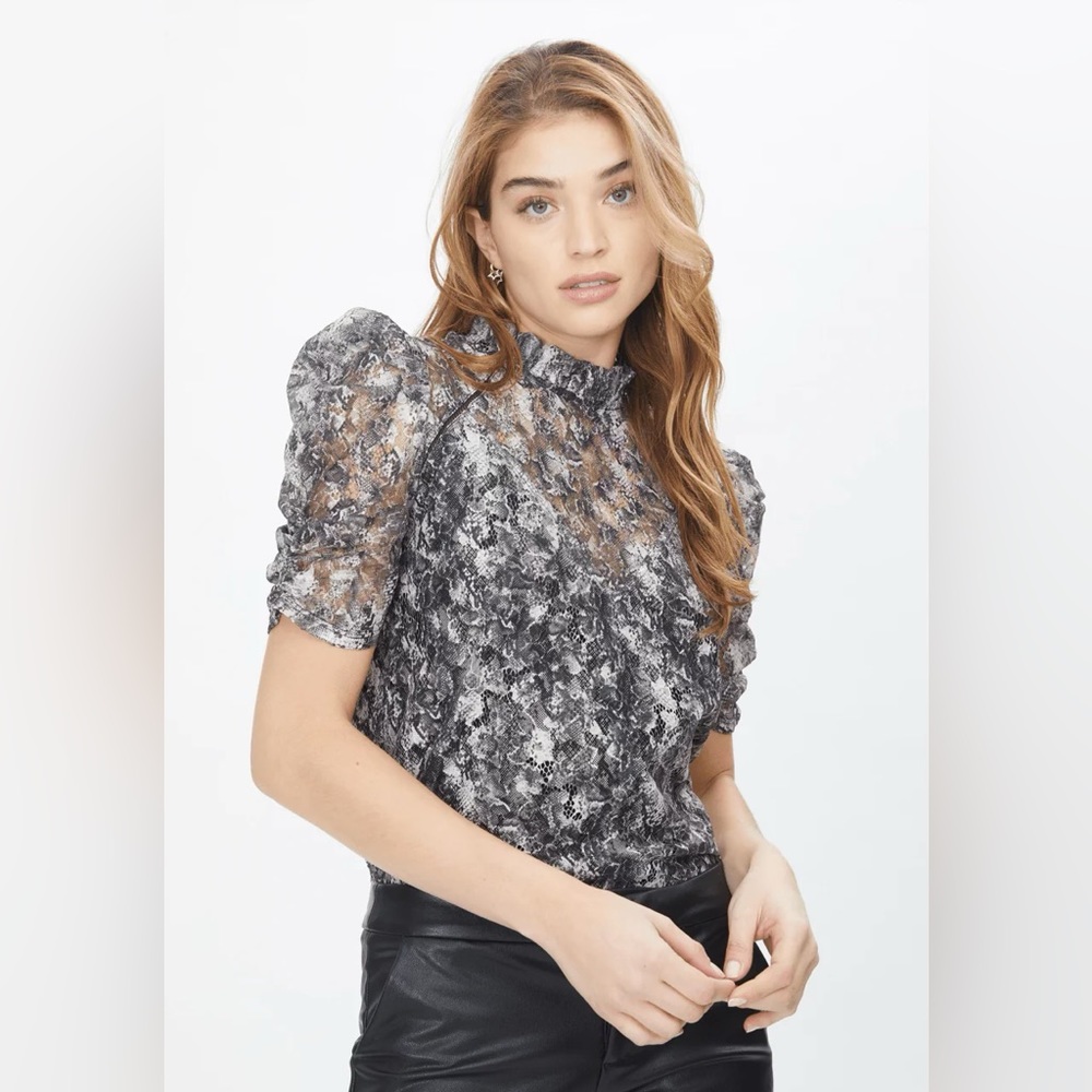 Black, white, grey lace top with puff sleeves a d ruffled mock neck.